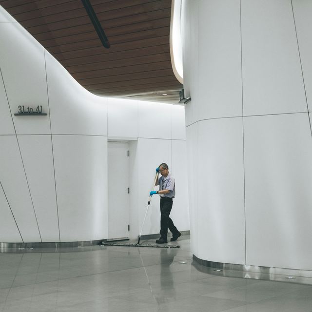 Cleaner mopping a large commercial lobby floor