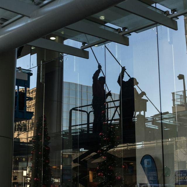 Window washers cleaning commercial building glass